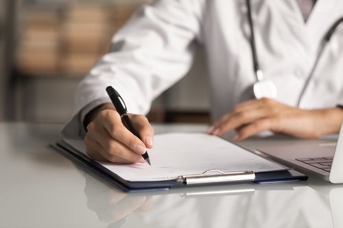 Image is of a doctor taking notes concept of medication management in Chicago