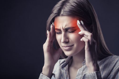 Image is of a woman suffering a bad migraine concept of treatments for migraines and headaches in Chicago
