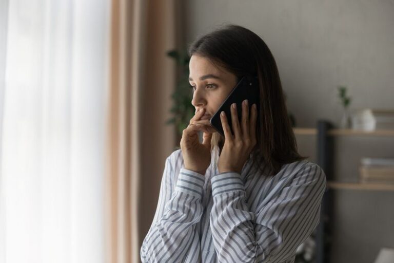 Image is of a frustrated woman on the phone concept of tips for dealing with insurance companies after a personal injury