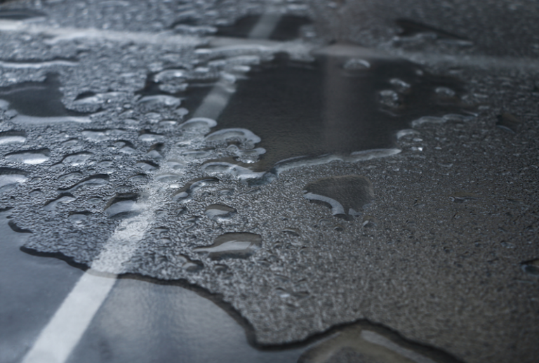 Image is of a wet tile floor, concept of slip and fall injury liability